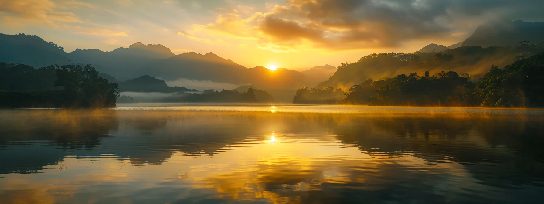 a breathtaking sunrise casts golden hues over a tranquil lake surrounded by misty mountains, reflecting the serene beauty of nature.